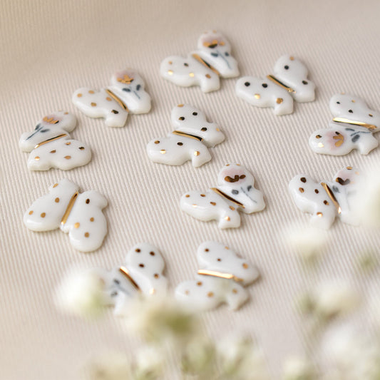 Butterfly earrings detail – delicate butterfly motif with 24k gold ceramic decoration, by Joska Handmade