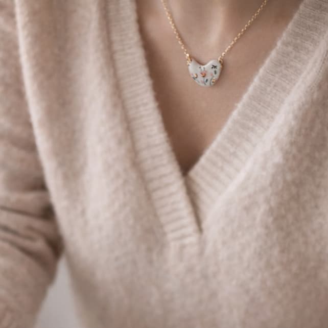 Little Bird necklace detail – the signature of Joska Handmade, 24k gold ceramic decoration