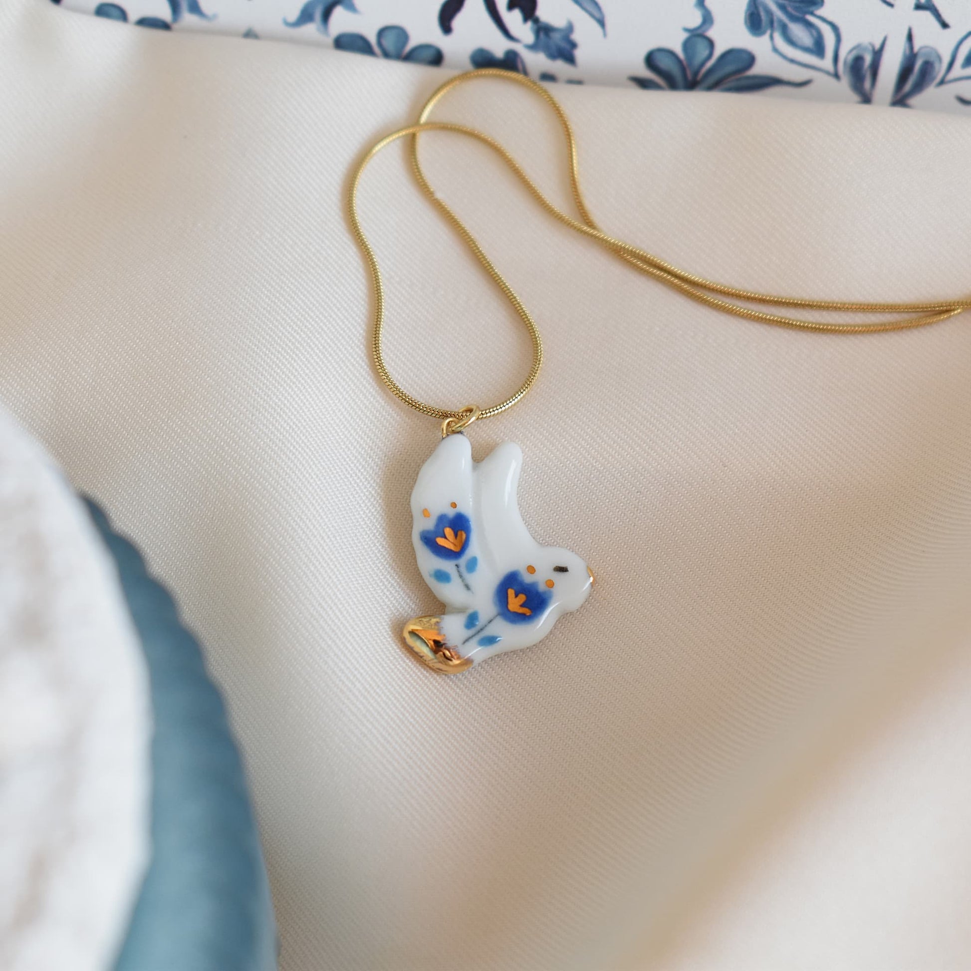 Dove Freedom necklace detail – graceful dove motif with 24k gold ceramic decoration, by Joska Handmade
